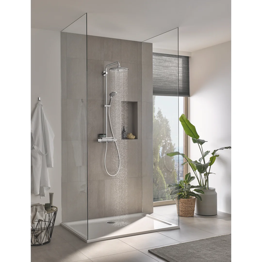 GROHE Vitalio Joy 260 shower system with CoolTouch thermostat with tray, 260mm 3-spray head shower and 110mm 3-spray hand shower in chrome. Water-savi